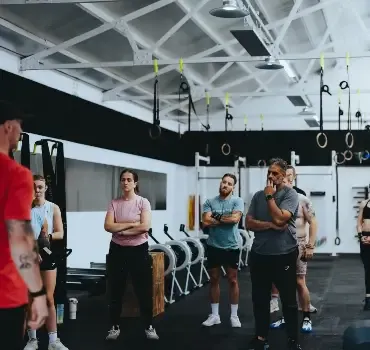 A group of members training together with a coach at Troy City Fitness